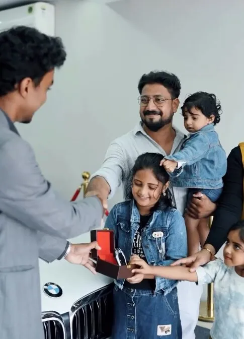 A family collecting their new BMW